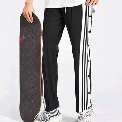 Pantalons de piste de skateboard sur la rue hip hop sur mesure pour hommes respirants avec bande latérale et boutons